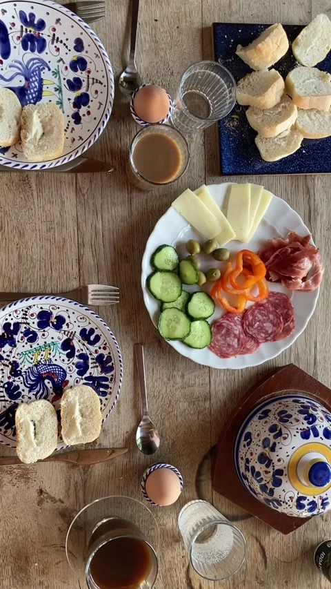 Breakfest table with bread, cheese, salami, olives and coffee zoom out Stock Footage 340885221