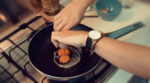 Breaking and cooking eggs in a pot Stock Footage 63429734