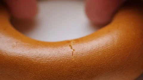Breaking a bagel in macro photography Video stock 104596285