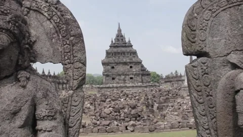 Breaking in between 2 cracked Buddha statues Stock Footage 243794049