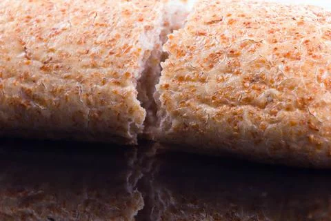 Breaking Bread on a dark glass background bread is main food of humans sin... Stock Photos