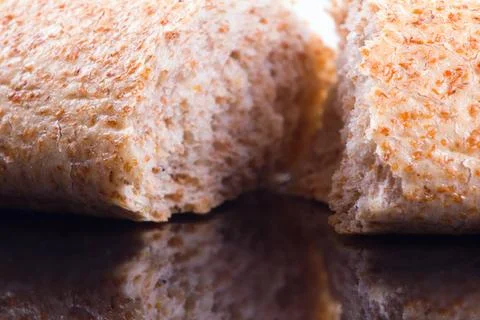 Breaking Bread on a dark glass background bread is main food of humans sin... Stock Photos