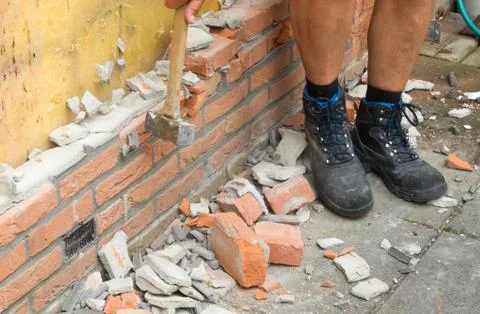 Breaking up a brick wall Stock Photos