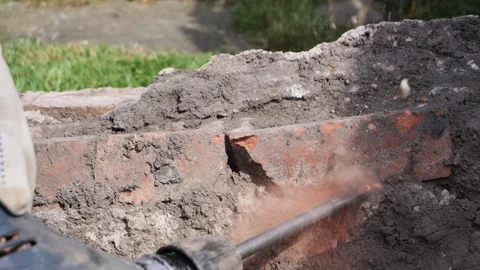 Breaking bricks out of concrete with breaker in slow motion Stock Footage 275297789
