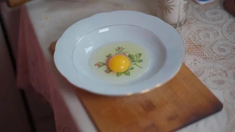 Breaking Chicken Eggs to Get Yolks Stock Footage 129517935