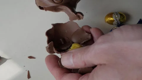 Breaking Chocolate Easter Bunny to Reveal Sweet Candy Surprise Stock Footage 331910600