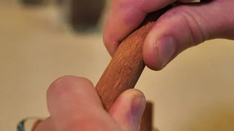 Breaking cinnamon stick with his hands Stock Footage 164243429