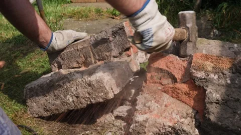 Breaking concrete and brick by hand with a lump hammer Stock Footage 275297982