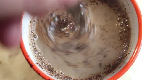 Breaking a cup of coffee. Steaming substance with bubbles in full HD.  Stock Footage 262444313