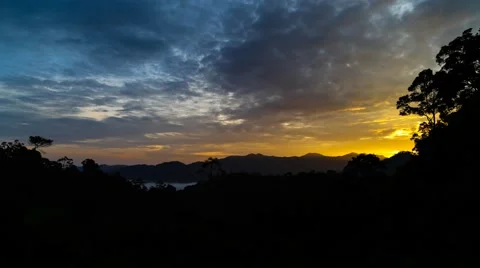 Breaking of dawn time-lapse with moving clouds at a tropical highland jungle Stock Footage