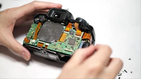 Breaking down and disassembly of a digital camera for parts and components Stock Footage 266385923