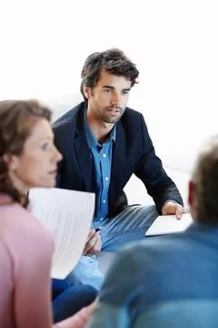 Breaking down a retirement plan for them. A young consultant giving advice to a Stock Photos