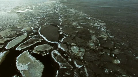 Breaking edge of ice cover with ice raft fragments in spring, aerial shot Stock Footage 63157743
