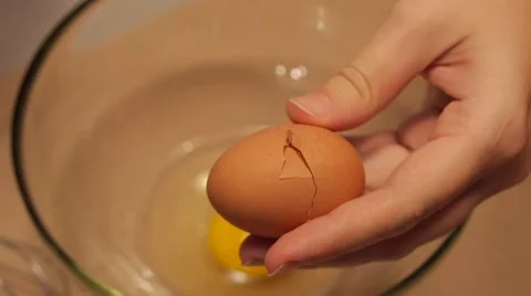 Breaking an egg into a bowl in slow motion 2 Stock Footage 49074942