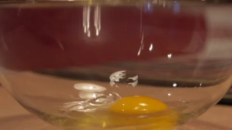 Breaking an egg into a bowl in slow motion 1 Stock Footage 49074991