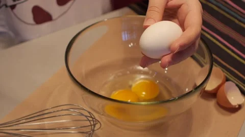 Breaking an egg into a bowl in slow motion 3 Stock Footage 49075072