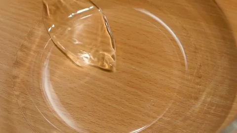 Breaking egg for cooking in deep glass dish, slow motion Stock Footage 76166636