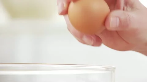 Breaking an egg Stock Footage 24649356