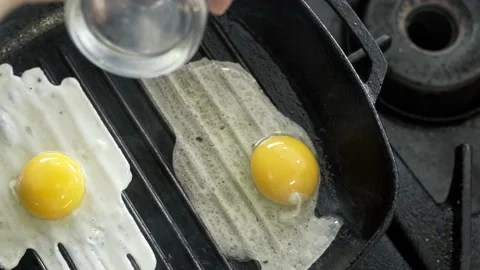Breaking Egg On Frying Pan. Egg falling on hot frying pan in slow motion. Stock Footage 238626964