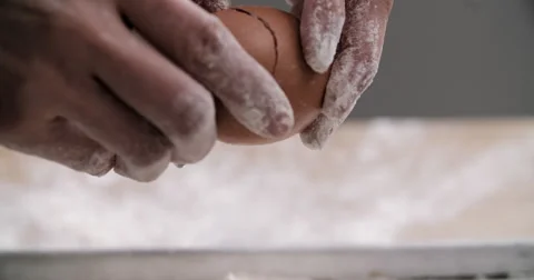 Breaking egg over flour Stock Footage 55879247
