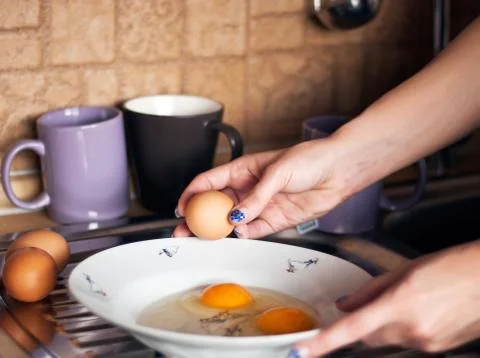 Breaking an egg Stock Photos