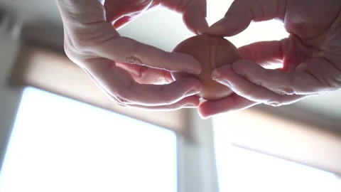 Breaking egg, slow motion shot from the bottom Stock Footage 150673326