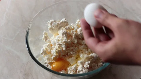 Breaking eggs in a cheese Stock Footage 113353576