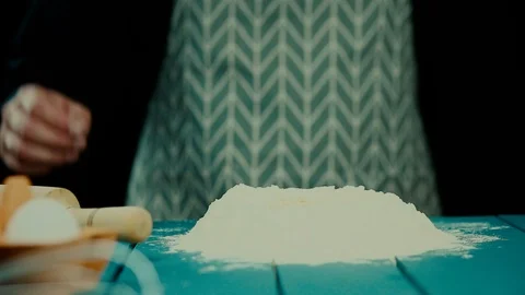 Breaking eggs in the flour. Stock Footage 120238993
