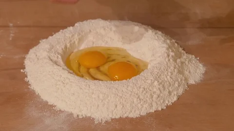 Breaking eggs for fresh pasta han made. Stock Footage 84011632