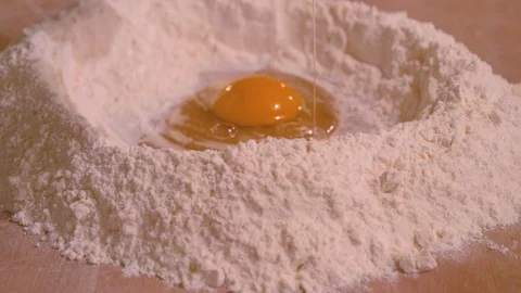 Breaking eggs for fresh pasta han made. Stock-Footage 84030184