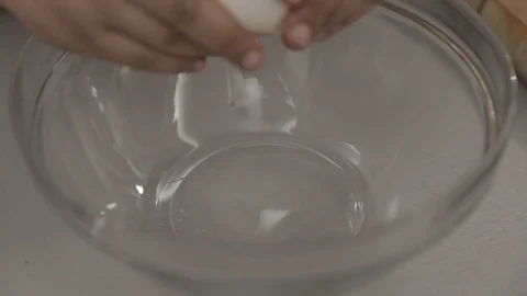 Breaking eggs in slow motion Stock Footage 76370892