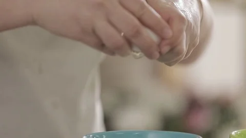 Breaking eggs in slow motion Stock Footage 76372499