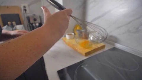 Breaking the eggs with a whisk. Making pancakes. Stock Footage 113059067