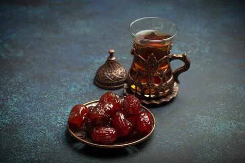 Breaking fasting with dried dates during Ramadan Kareem, Iftar meal with dates Stock Photos