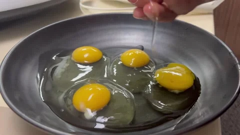 Breaking fresh eggs and whisking for cooking, close-up Video stock 329285092