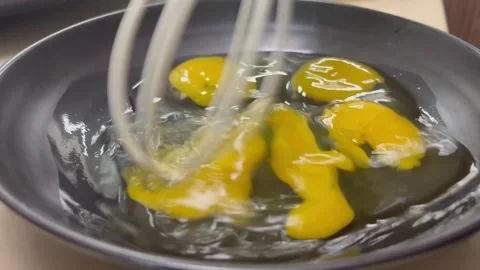 Breaking fresh eggs and whisking for cooking, close-up Stock Footage 329285103