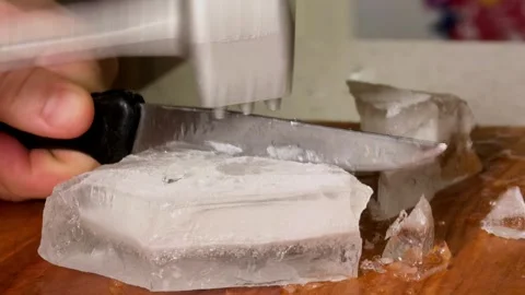 Breaking Ice Block With Meat Tenderizer And Knife Stock Footage 339550924