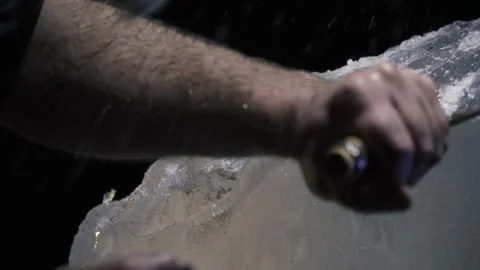 Breaking off ice pieces with a chisel and hammer, ice sculpture making, 4k Stock Footage 153587474