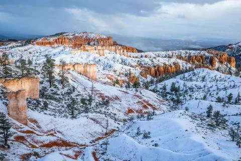 Breaking light through winter storm clouds after snow falls in southern Utah' Stock Photos