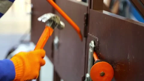 Breaking the lock in the door with a hammer and crowbar Stock Footage 115048216