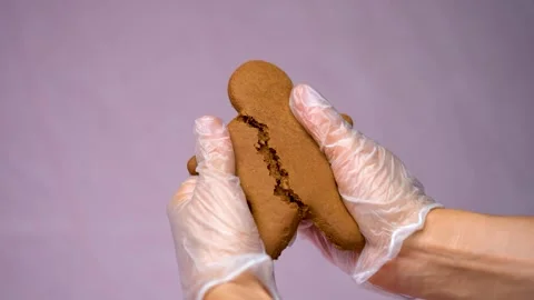 Breaking Man Shaped Christmas Cookie in Half Close Up Stock Footage 330517253