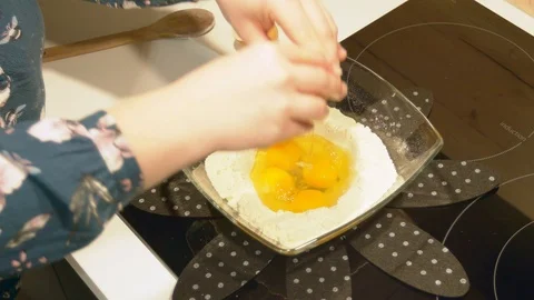 Breaking more eggs and mixing with the flour to prepare French pancake batter. Stock Footage 102405624