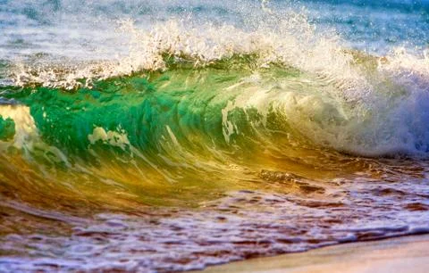Breaking ocean wave at sunset Foto stock