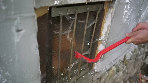 Breaking old latticed window with crowbar Stock Footage 158979664