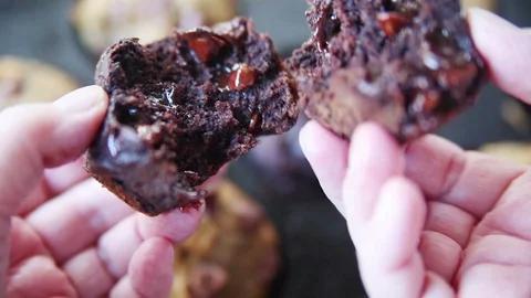 Breaking open a chocolate muffin Stock Footage 102752578