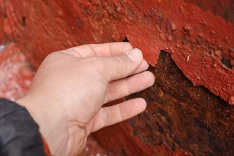 Breaking off paint scaling by hand Stock-Fotos