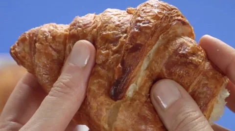 Breaking off a piece of croissant Stock Footage 8570439