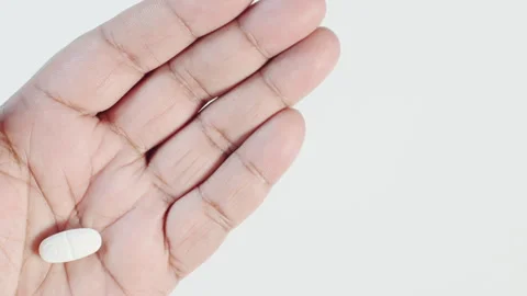 Breaking a Pill In the Hand Stock Footage 248776387