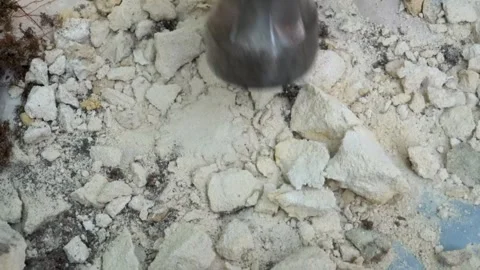 Breaking rock pieces with a hammer Stock Footage 276423757