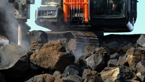 Breaking rocks using an Excavator breaker Stock Footage 275248240